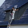 Krause Fabilo Schiebeleiter mit Mann bei Fassadenarbeiten an einem Haus.