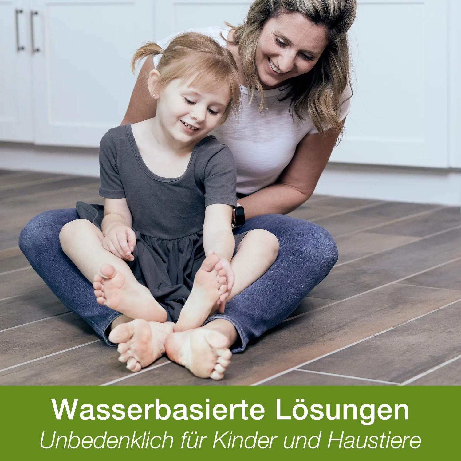 Mutter und Kind sitzen auf Boden gereinigt mit Bona Stein-, Fliesen- und Laminatreiniger.