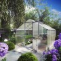 KGT Gewächshaus Orchidee Alu blank, 12,74 m², mit geöffneter Tür im Garten.