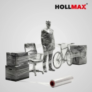 Transparente HOLLMAX Profi Stretchfolie umwickelt verschiedene Gegenstände wie Kartons, Stuhl und Fahrrad für sicheren Transport.