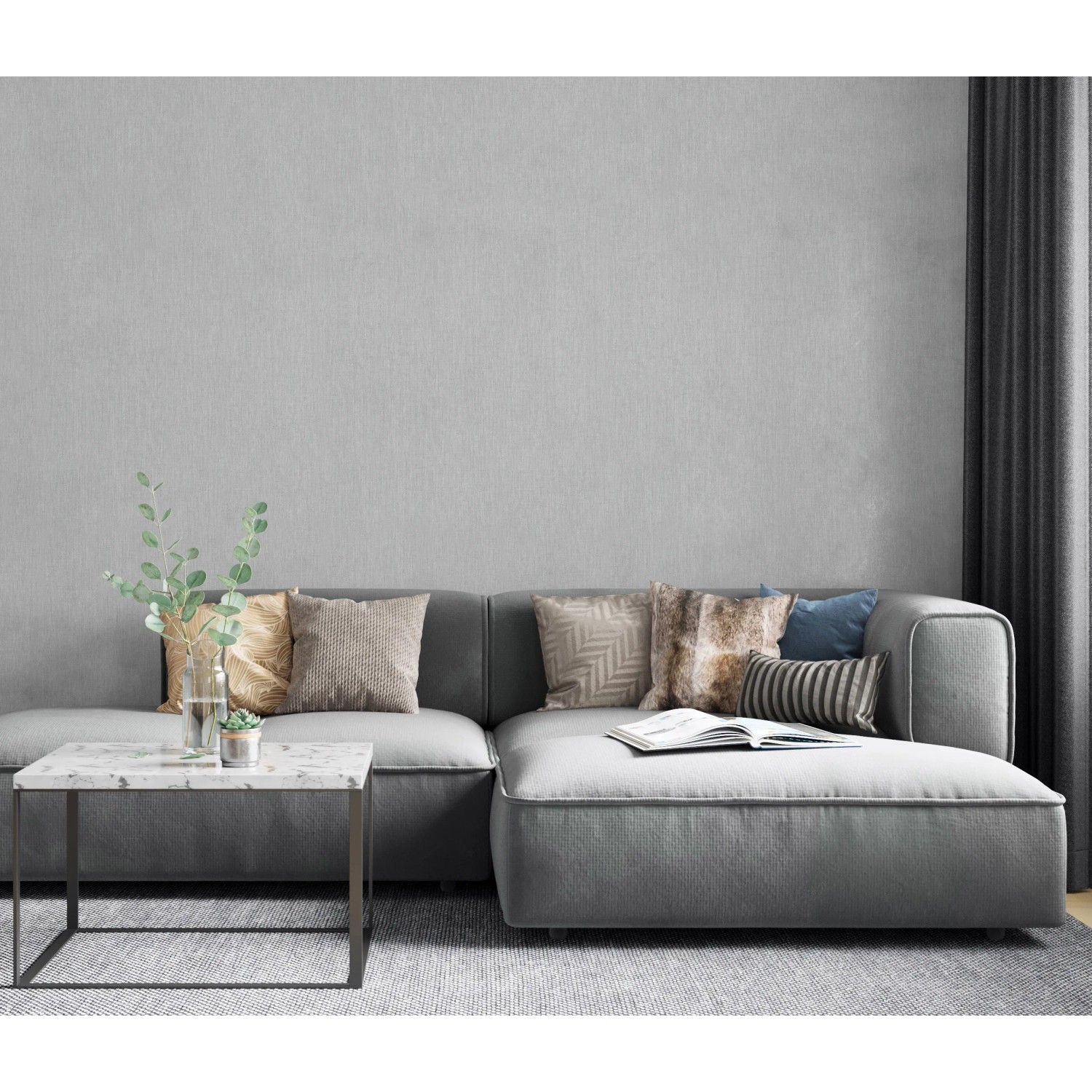 Wohnzimmer mit grauer Marburg Vliestapete Botanica 2 Uni und passendem Sofa.