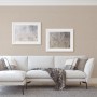 Beige Vliestapete von Guido Maria Kretschmer im Wohnraum mit Sofa und Bildern.