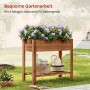 Braunes Holz-Hochbeet mit lila Blumen, integriertem Blumenkasten und Ablage für Gartengeräte im Garten.