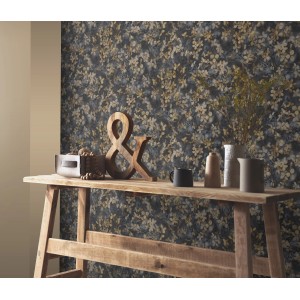 Erismann Vliestapete Play of Light Purity Schwarz mit floralem Muster an Wand hinter Holztisch.