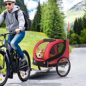 Roter PawHut Hundeanhänger am Fahrrad mit Hund. Ideal für sicheren Transport von Kleintieren.