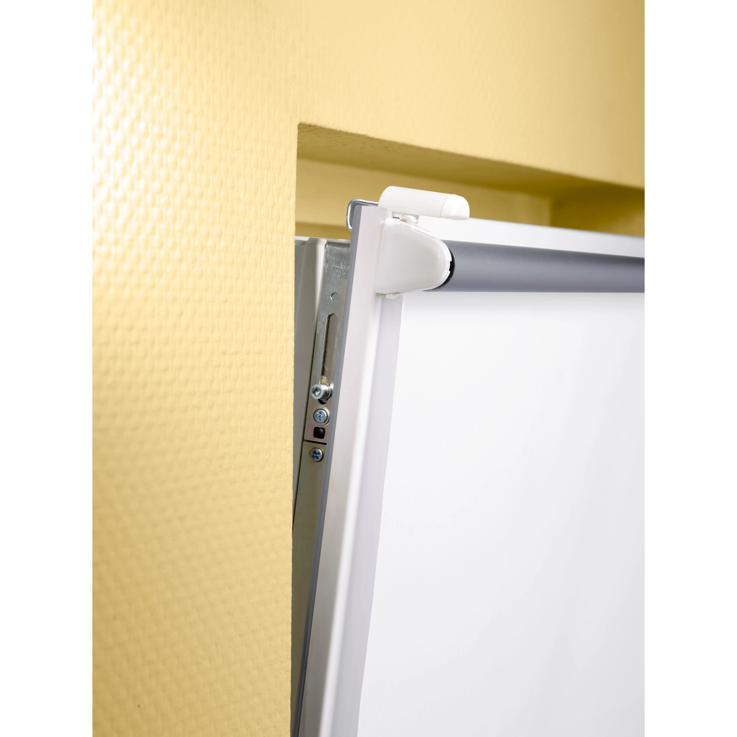 Detailaufnahme: Weißes Hitzeschutzrollo Manresa, 45x175 cm, mit Easyfix-System am Fensterrahmen.