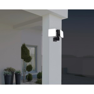 Schwarze LED-Wand-Außenleuchte Jaro II mit Bewegungsmelder an einer weißen Säule.