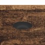 Nahaufnahme einer Couchtisch-Schublade in Altholz-Optik mit schwarzem Muschelgriff aus Holzwerkstoff.