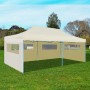 Cremefarbenes, faltbares 3x6 m vidaXL Partyzelt mit Seitenwänden und Fenstern auf einer grünen Wiese.