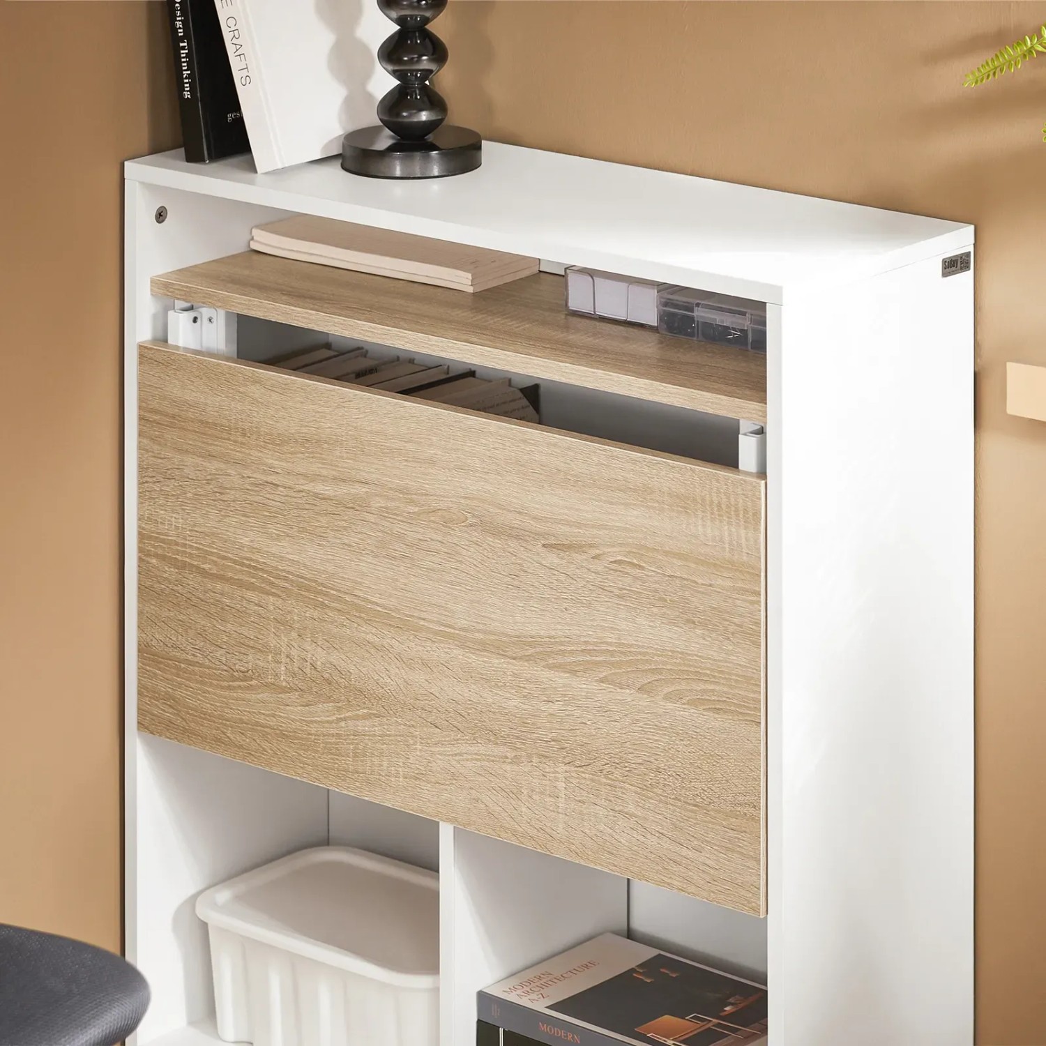 Weißer Klapptisch-Schrank mit naturfarbener Holzoptik-Tischplatte, als Tür geschlossen. Platzsparender Bürotisch mit Regal.