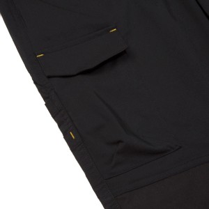 Detailansicht: Schwarze Cat Arbeitshose Nexus Stretch mit Cargo-Tasche.