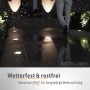 Schwarze SSC-LUXon Juavi Bodeneinbaustrahler (4er Set) im Außenbereich, beleuchten einen dunklen Weg.