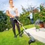 Frau trimmt Rasen mit LUX Akku-Rasentrimmer A-RT-20/26 1 PowerSystem im Garten.