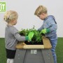 EXIT Aksent Hochbeet L aus Holz mit zwei Kindern beim Gärtnern.