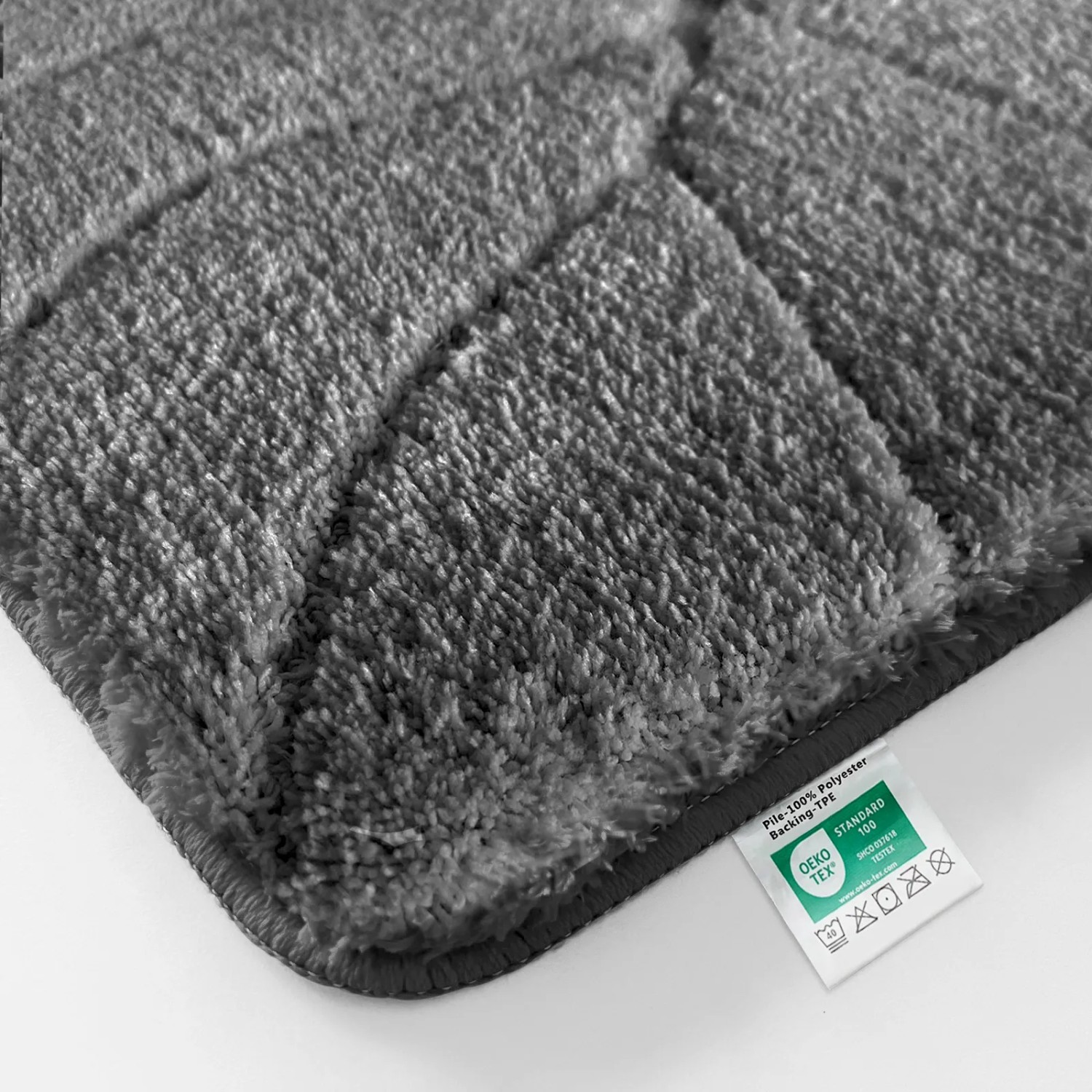 Dunkelgraue Karat Badematte Maris (50x80 cm) mit Blattstruktur.