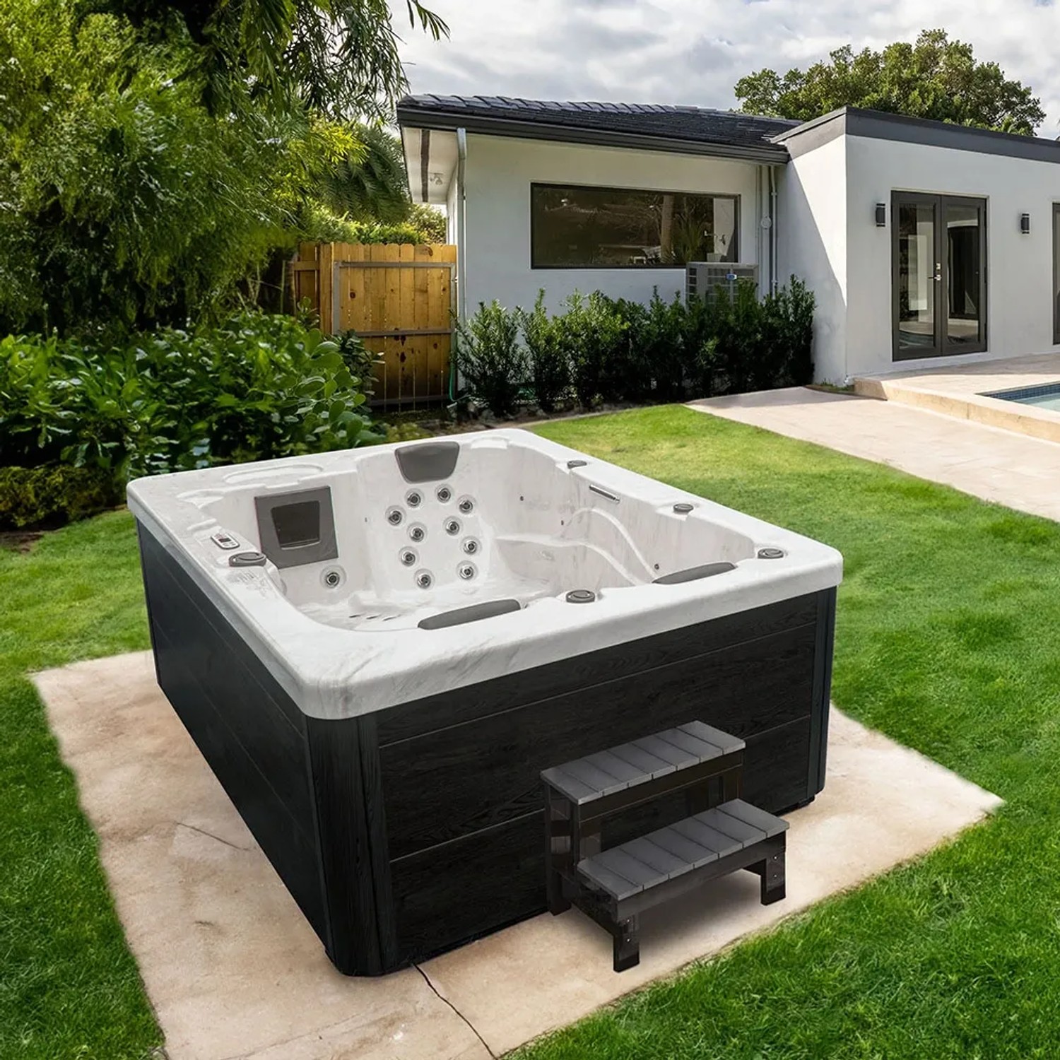 Home Deluxe Outdoor Whirlpool White Marble mit Treppe und Abdeckung im Garten.