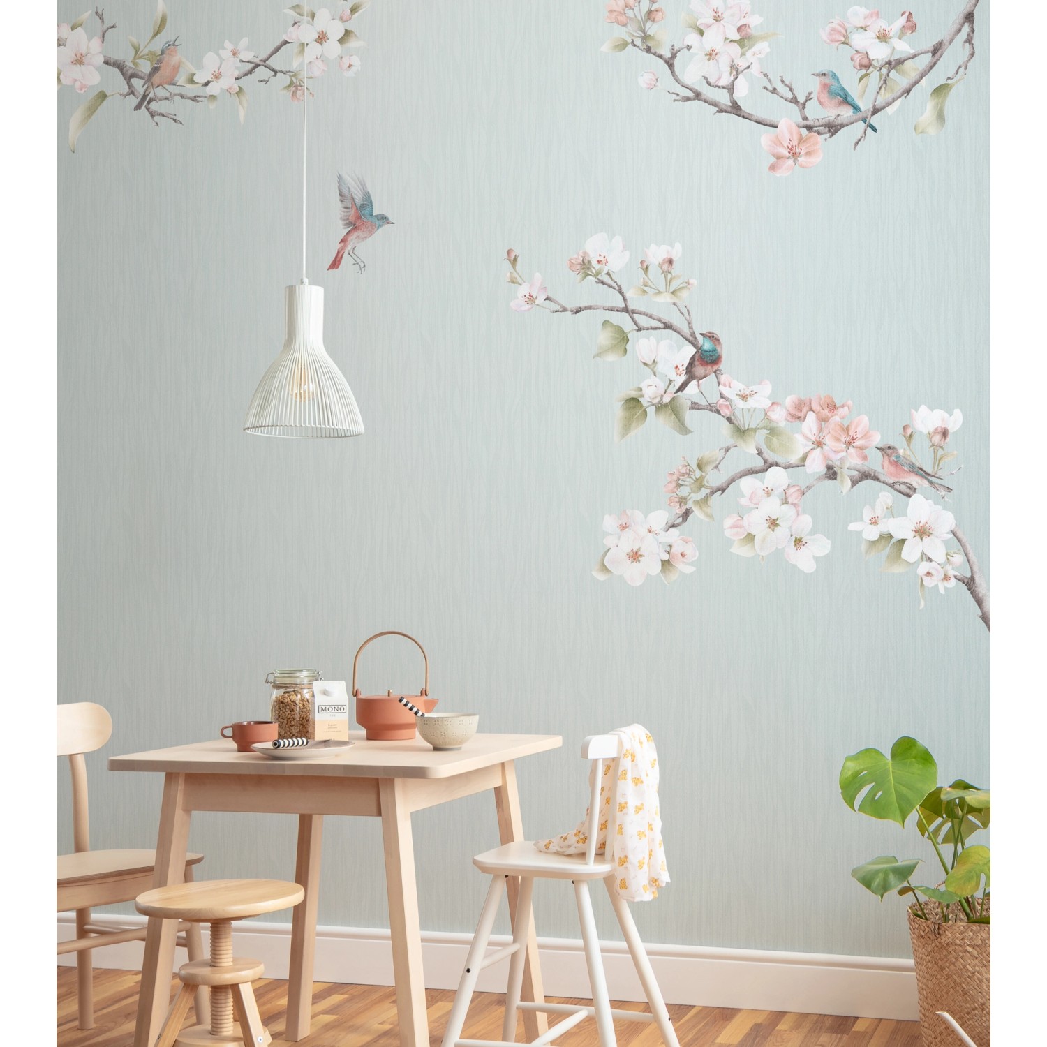Komar Vliesfototapete Apple Bloom mit Blüten und Vögeln an einer Wand im Esszimmer.