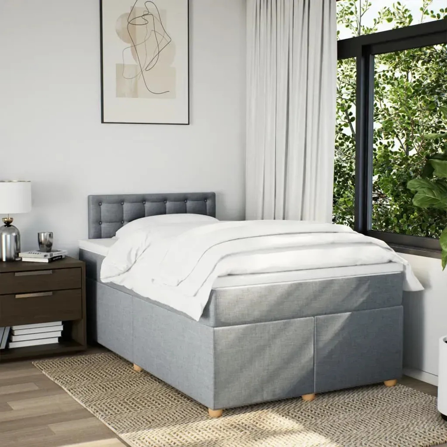 Helles Boxspringbett 120x200 cm mit Matratze und grauem Stoffbezug im Schlafzimmer.