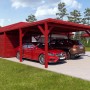 Holzbrüder Doppelcarport Ralf mit Geräteraum, oxidrot, mit zwei parkenden Autos.