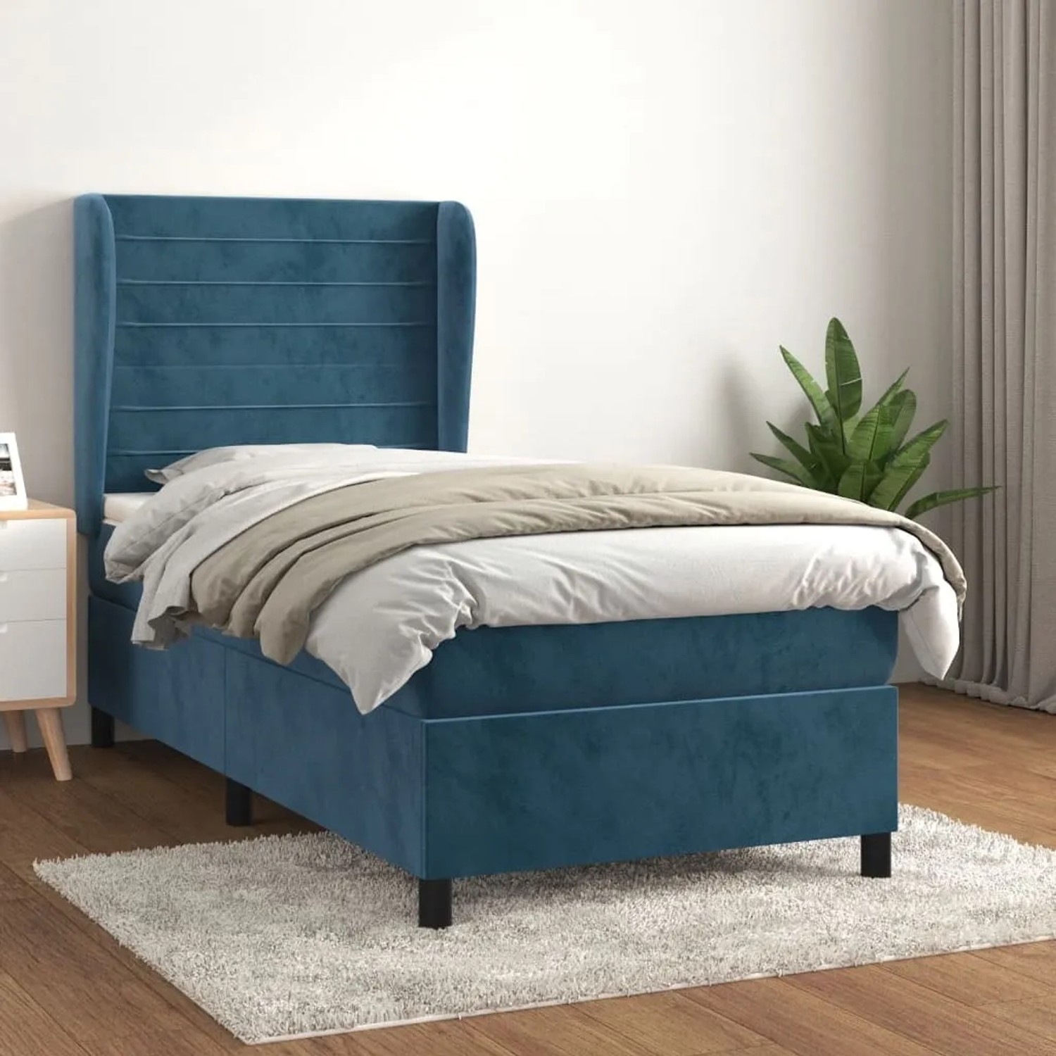 Dunkelblaues Boxspringbett (80x200 cm) mit Samtbezug, Matratze und Kopfteil im Schlafzimmer.