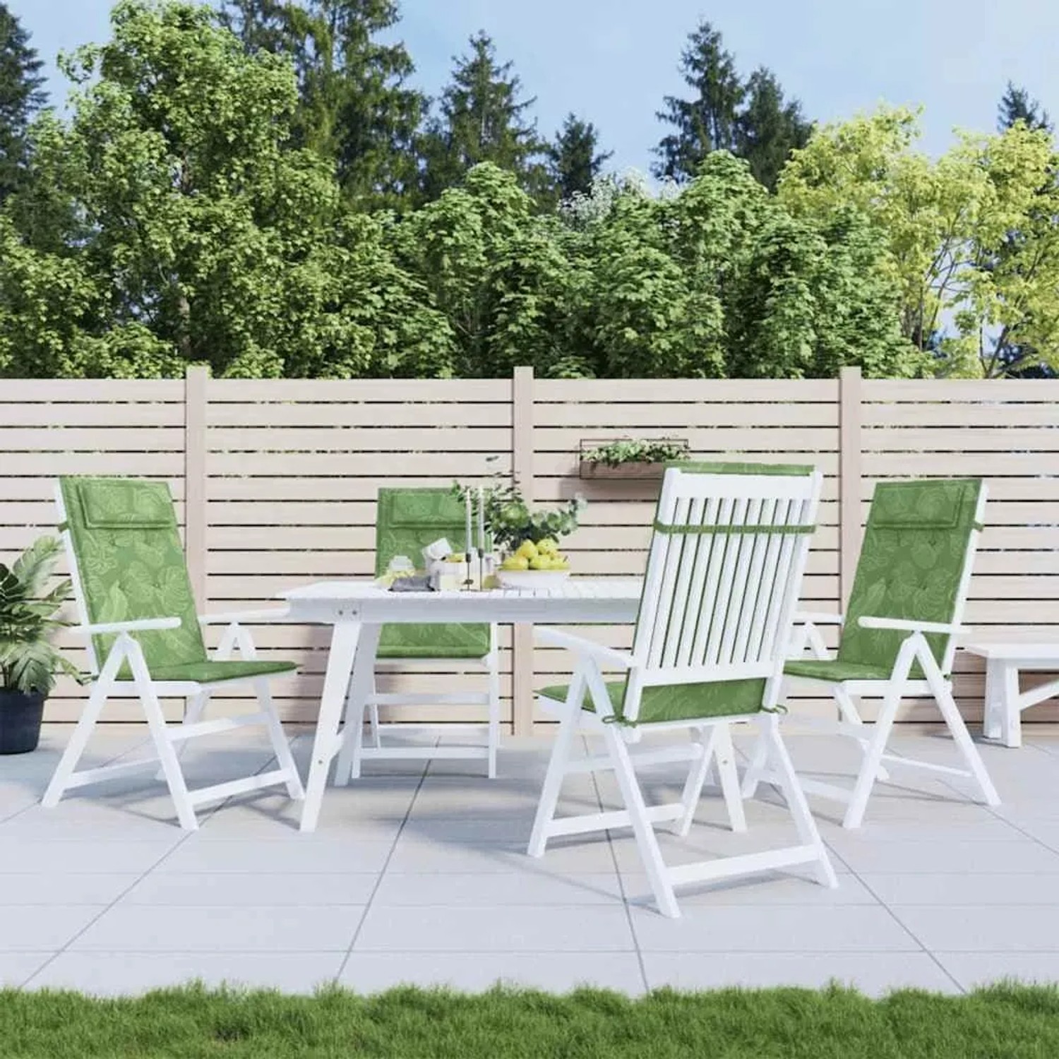 Vier grüne Hochlehner-Auflagen mit Blattmuster auf weißen Gartenstühlen. Ideal für Garten & Terrasse.