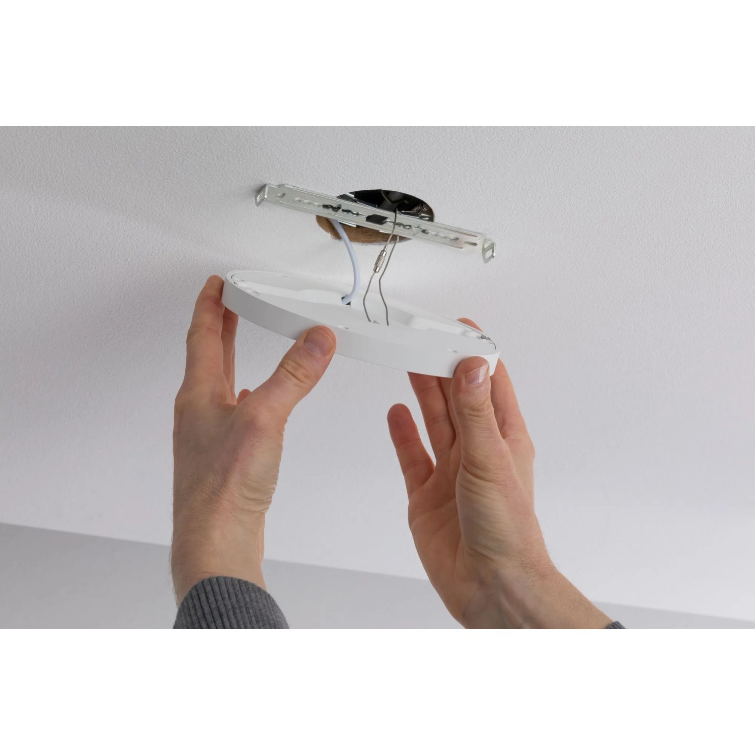 Montage eines weißen, runden Paulmann LED-Einbaupanels (6W) in eine Decke.