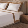 Weißes Baumwoll-Bettwäsche-Set für Doppelbett mit beiger Satin-Bordüre an Decke und Kissen.