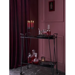 Dekorative schwarze Marmorschale Midnight Mystery auf Servierwagen mit Deko-Elementen.