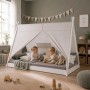 Weißes Homestyle4u Tipi Kinderbett 90x200 cm aus Kiefernholz mit Sternen-Zeltstoff. Zwei Kinder spielen auf der bodentiefen Liegefläche.