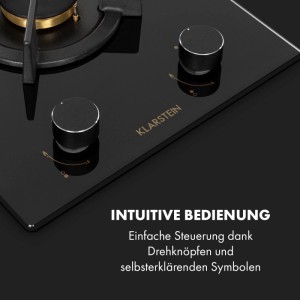 Schwarzes Klarstein Goldflame Domino Gaskochfeld aus Glaskeramik. Detailansicht mit Messing-Brenner, Gitter und intuitiven Drehknöpfen.