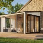 Graues Palmako Holz-Gartenhaus mit Pultdach und großen Glasfronten, integriert in Gartenlandschaft.