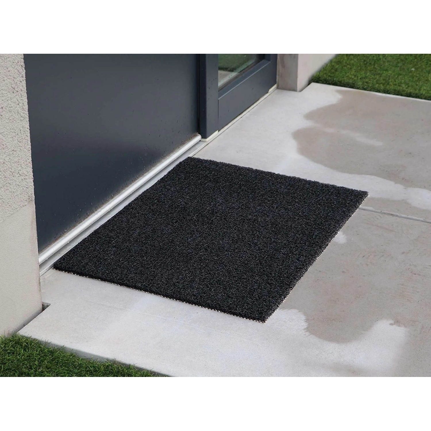 Anthrazitfarbene Primaflor Spaghettimatte Lorenzo 90x120 cm vor einer Tür.