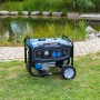 Blauer Güde Stromerzeuger GSE 3701 RS Benzin mit Tragegriff und Rädern vor Teich.