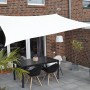 Weißes Floracord Vierecksonnensegel (250x300cm) spendet Schatten über einer Terrasse mit Tisch und Stühlen.