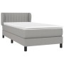 Helles Boxspringbett 90x190 cm mit Matratze und Kopfteil, Stoff hellgrau.