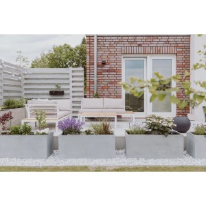 Graue Vivanno Pflanzkübel Maxi in Betonoptik (100x45x45 cm) im Garten.