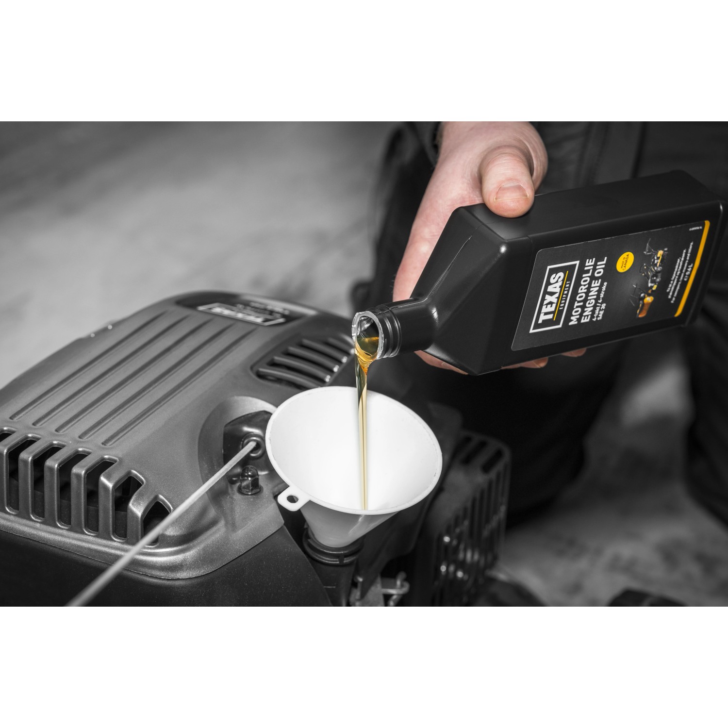 Texas Motoröl SAE30 wird in einen Rasenmäher eingefüllt.