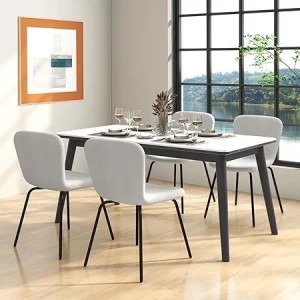 4 beige Esszimmerstühle mit schwarzem Metallrahmen um einen Tisch. Modernes Design, Samtbezug, Sitzhöhe 49cm.