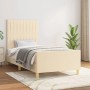 Cremefarbenes Stoff-Bettgestell 90x190 mit Kopfteil im Schlafzimmer.