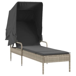 Hellgraue Poly Rattan Sonnenliege mit Dach und Tisch für den Garten.