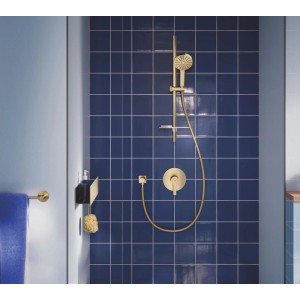 Gebürstetes Gold Grohe Vitalio Joy+ 120 Brausestangenset mit Handbrause, Schlauch und Armatur an blauen Fliesen im Bad.