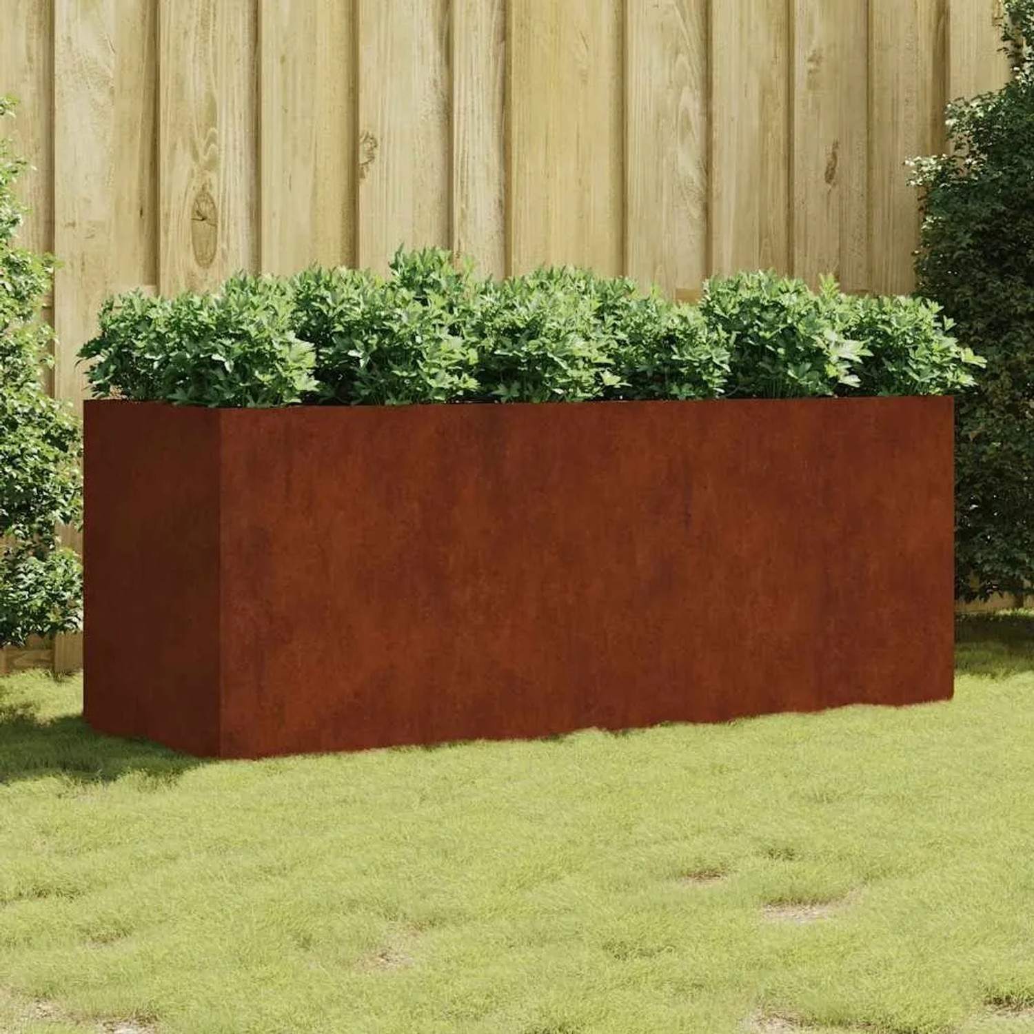Rechteckiges vidaXL Hochbeet aus rostigem Cortenstahl, bepflanzt, als Blumenkasten im Garten.