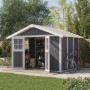Dunkelgraues Grosfillex Kunststoff-Gartenhaus Deco H 7.5 mit Doppeltür und Fahrrad im Garten.