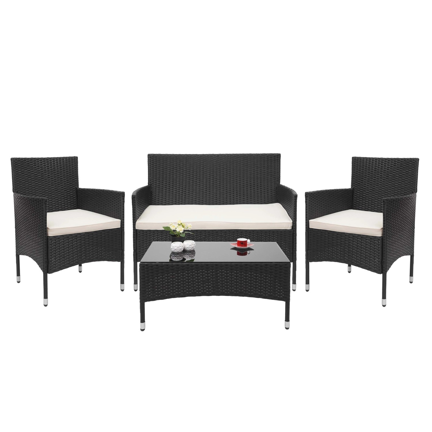 Schwarze 4-teilige Poly-Rattan Lounge-Garnitur mit creme-farbenen Kissen und Tisch mit Glasplatte.
