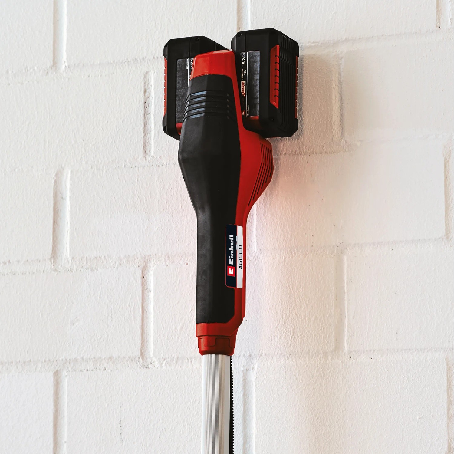 Einhell Akku-Sense Agillo Power X-Change Solo mit zwei Akkus an einer Wandhalterung.
