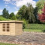 Karibu Holz-Gartenhaus Boras, unbehandelt, mit Flachdach im Garten.