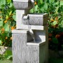Großer, mehrstufiger Design-Gartenbrunnen (H 80 cm) aus Kunststein mit LED-Beleuchtung.
