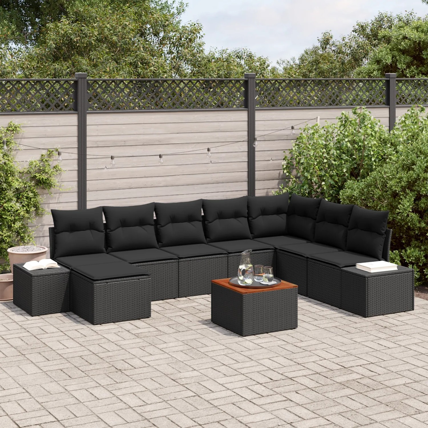 Schwarzes 9-teiliges Garten-Lounge-Set aus Polyrattan mit Tisch und Stauraum.