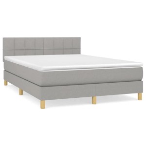 Helles Boxspringbett 140x200 cm mit Matratze und Kopfteil, Stoffbezug.
