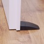 Schwarzer Wagner Bodentürstopper Black Deluxe (80x50x20mm) an einer Tür auf Holzboden.
